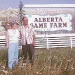 Couple posing in front of the game farm sign